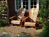 Classic Iroko Adirondack chairs in a cottage garden on the south coast