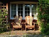 Classic Iroko Adirondack chairs in a cottage garden on the south coast