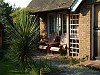 Classic Iroko Adirondack chairs in a cottage garden on the south coast